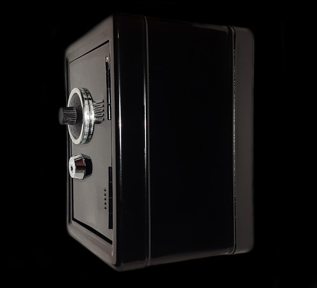 A dark colored combination lock safe perfect for storing jewelry.