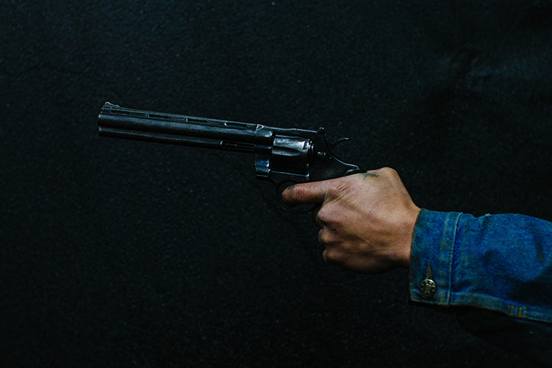 Person Holding Pistol