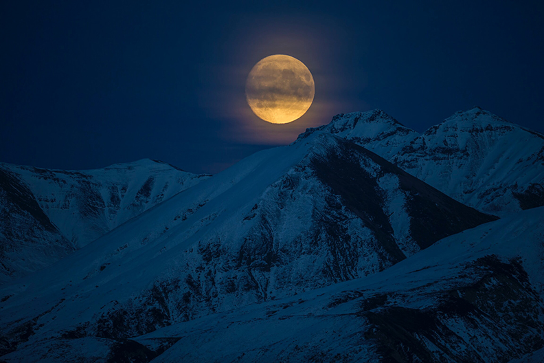 Night shot of Moon and mountains in Alaska