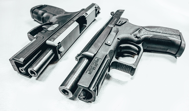 Two Hand Guns Lying Side By Side
