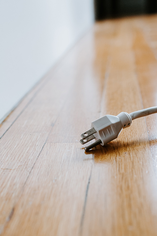 Unplugged cord on hardwood floor