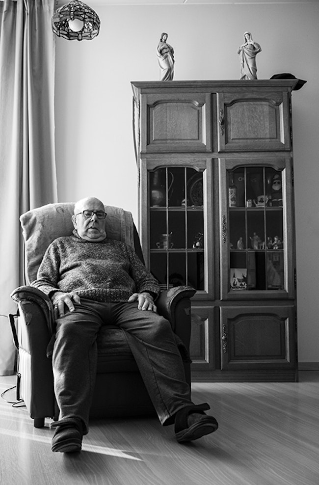 Elderly Man Sitting in Armchair