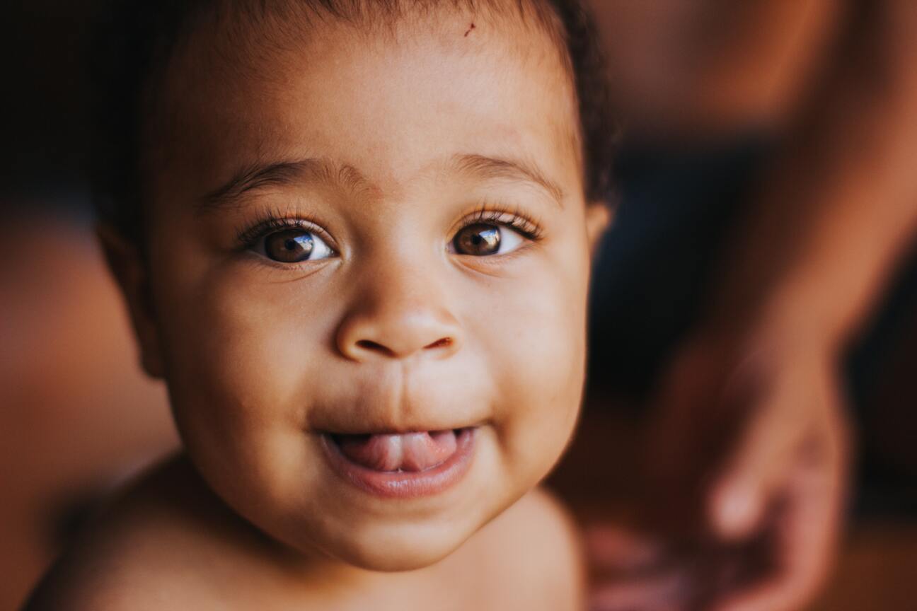 Happy baby sticking tongue out