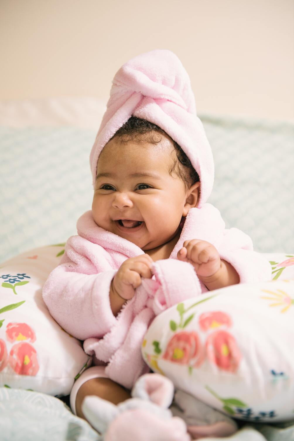 baby in bath robe laughing