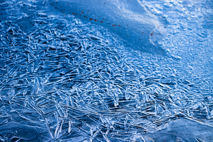 Frozen water creating overlapping lines in the morning light.