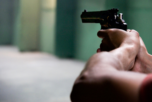 burglar holding a pistol with two hands