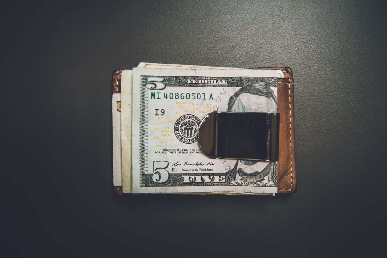 five dollar bill on the wallet