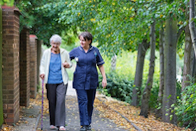 Nurse Walking Elderly Patient