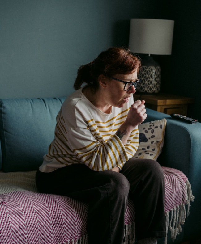 Woman Coughing due to poor air quality.