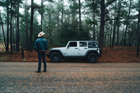 Person in Bastrop Texas with Jeep and cowboy hat