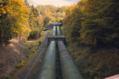 Water main pipes going through a forest in autumn.
