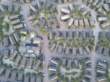 Birds-eye-view/aerial shot of gated communities at sunset.