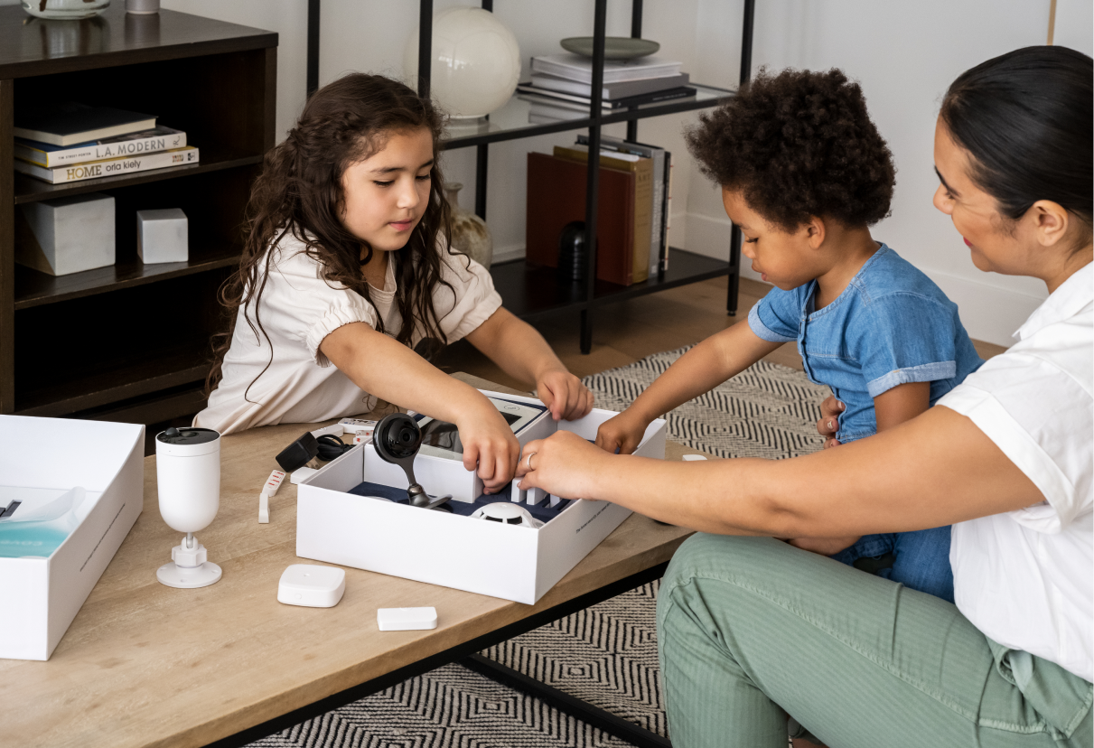 woman unboxing cove system with kids