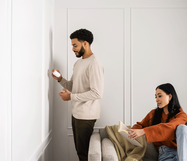 man installing motion sensor
