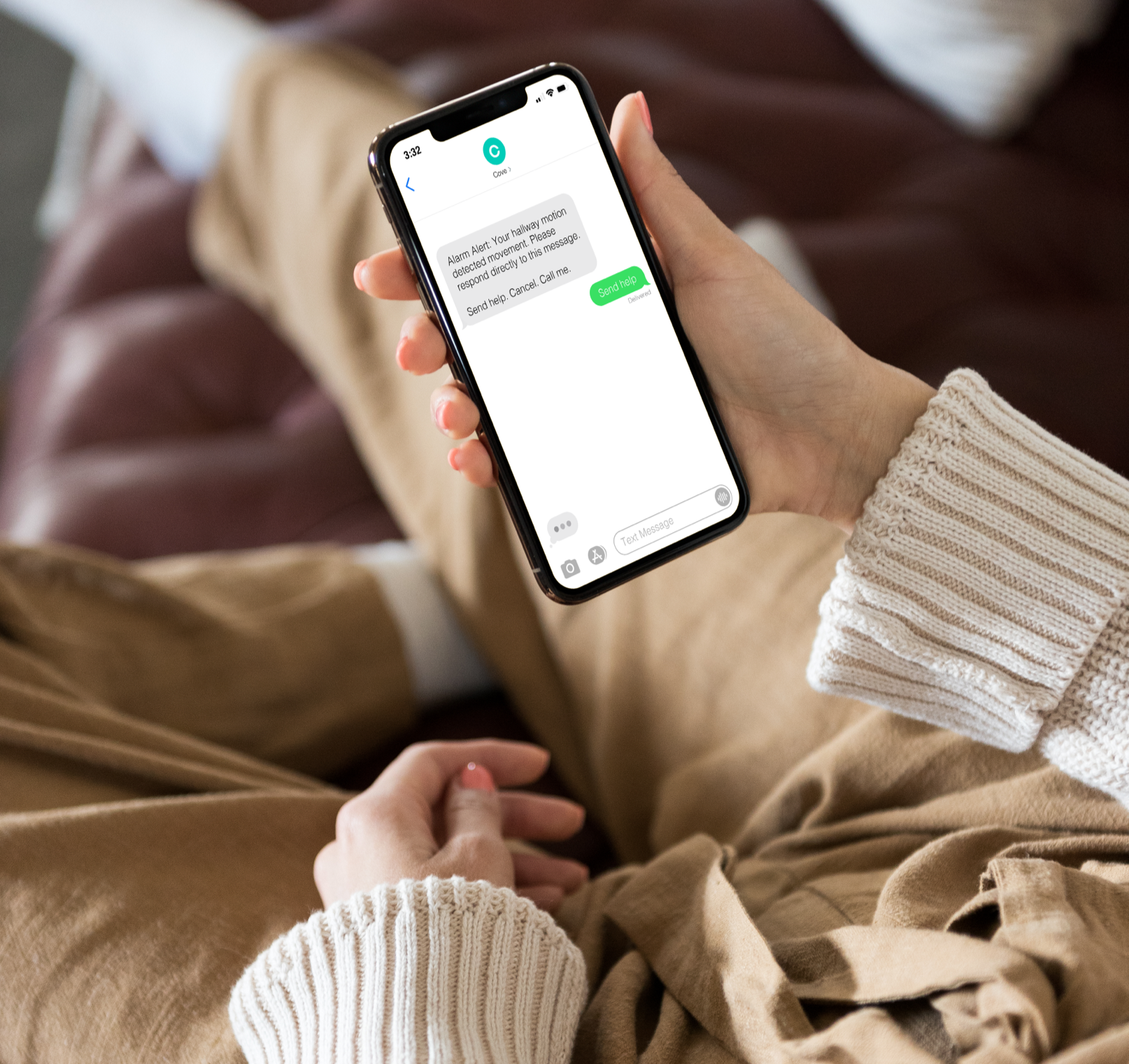 Woman holding phone reading Cove alarm messages