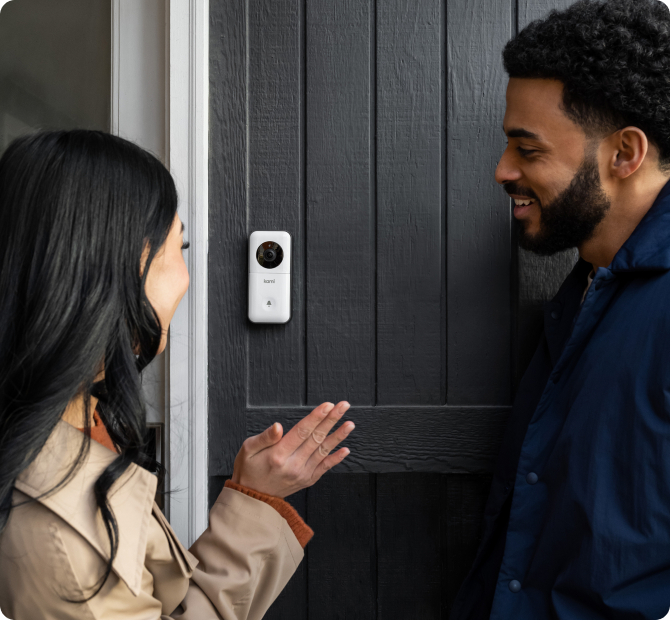 Woman waving at doorbell camera