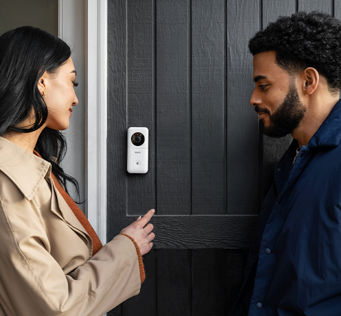 Woman waving at doorbell camera