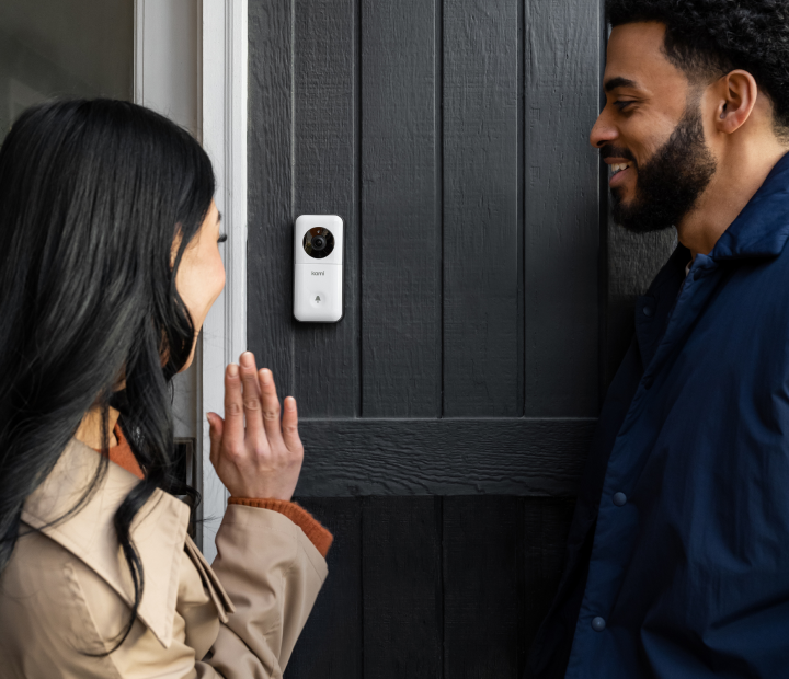 Visitors at the door talking into a doorbell camera.