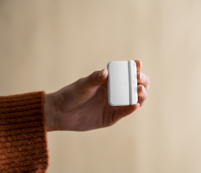Woman holding door sensor