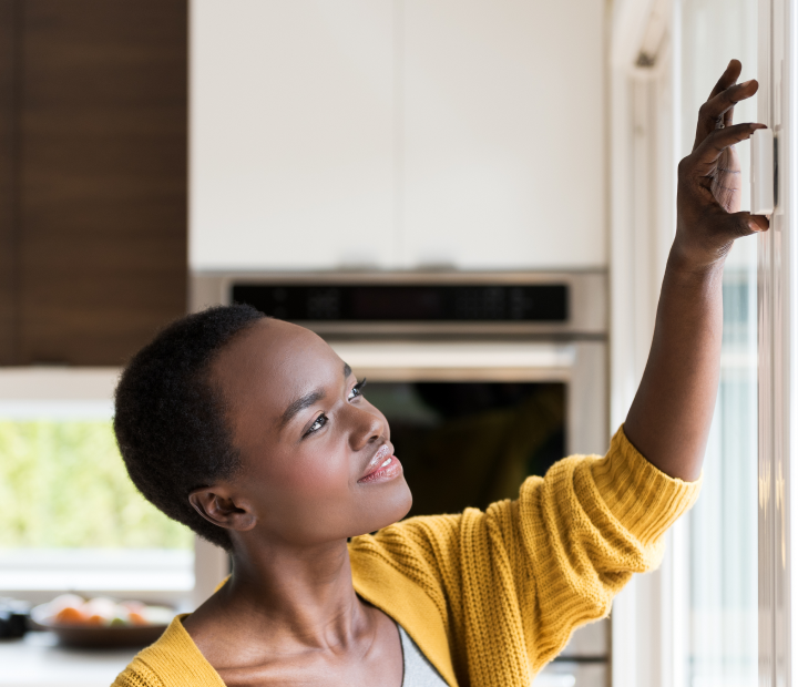 Woman installing door sensor