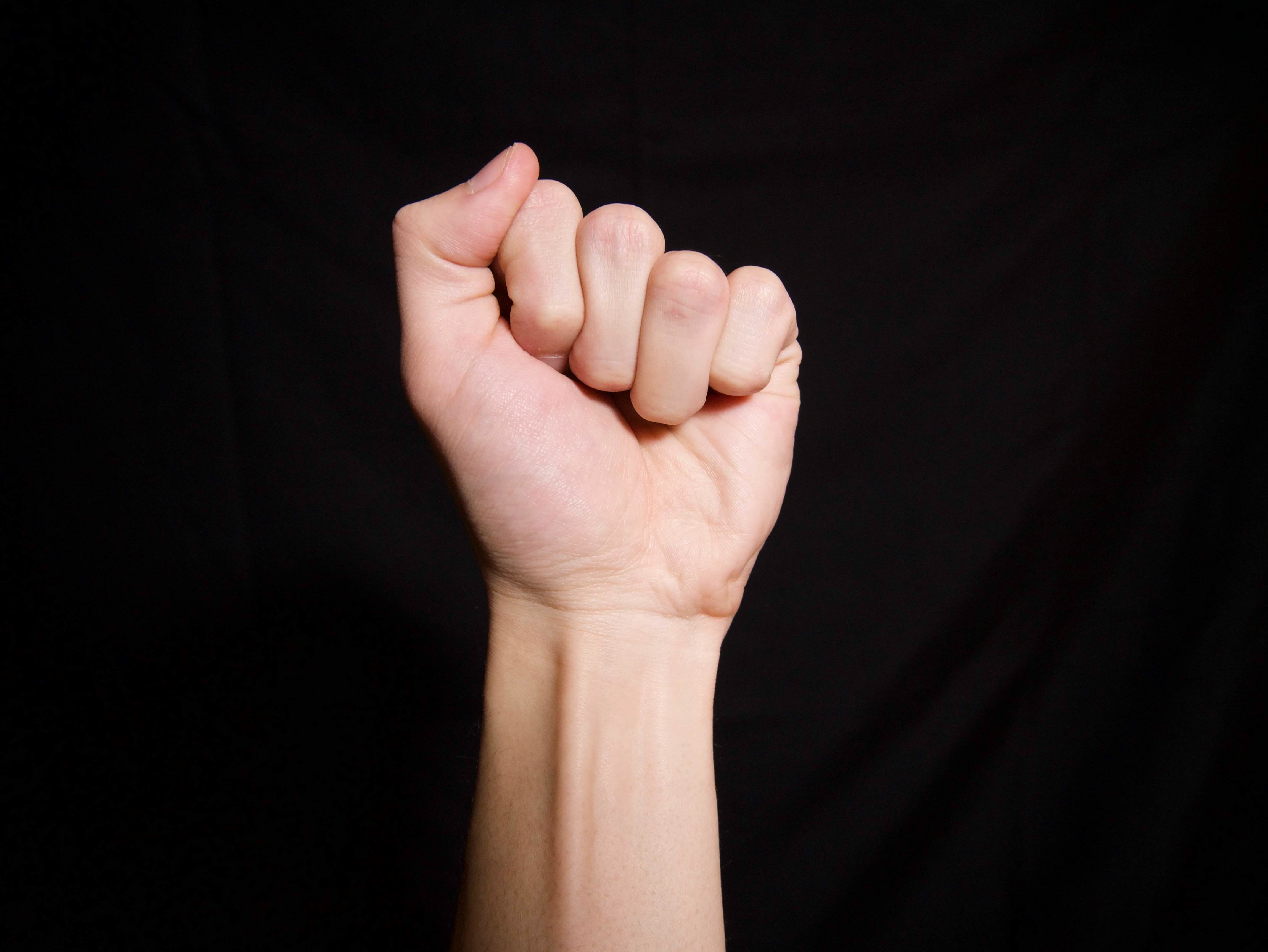 Left hand straight up as a fist.