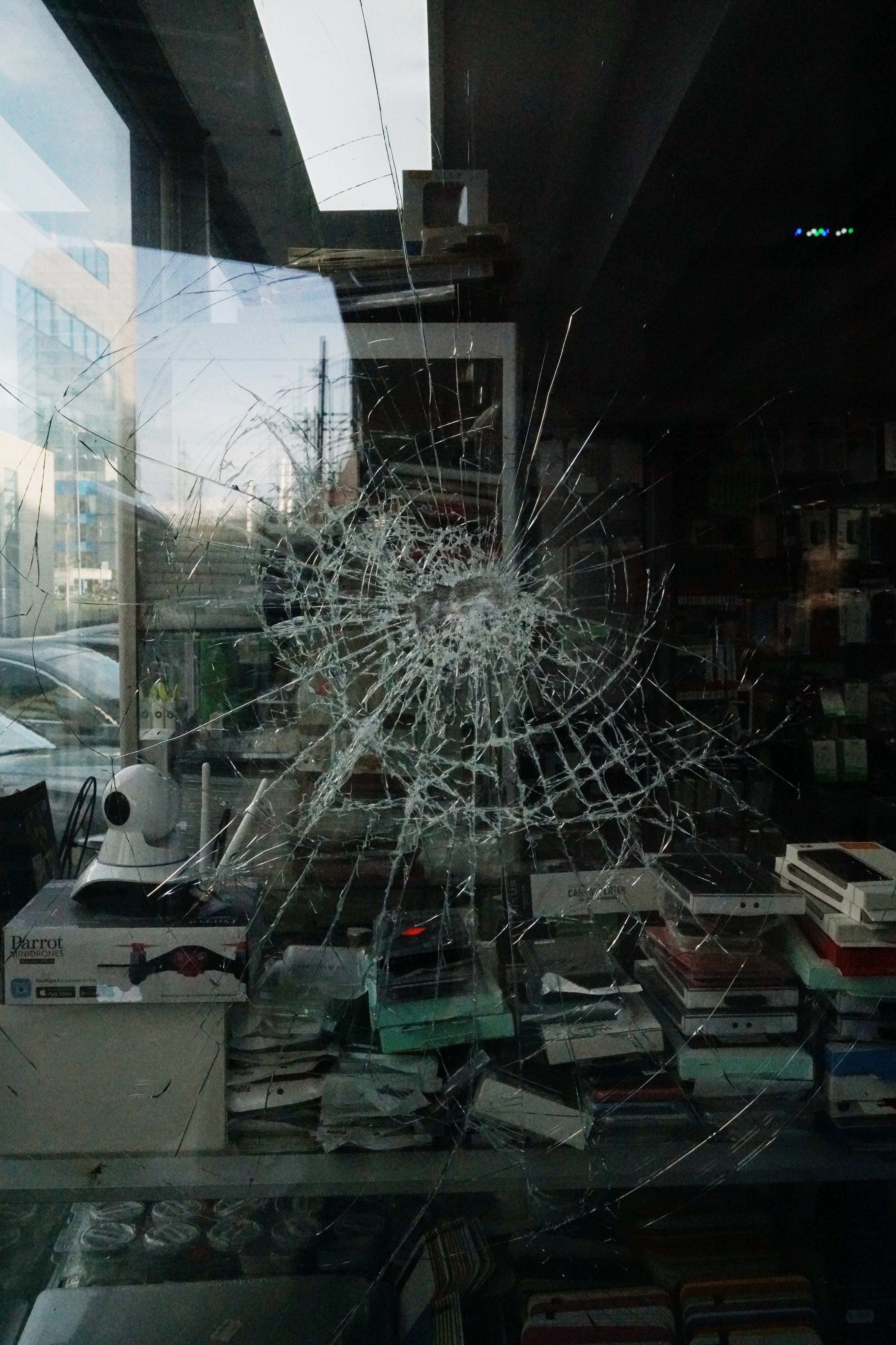 Broken window of a home with books inside.