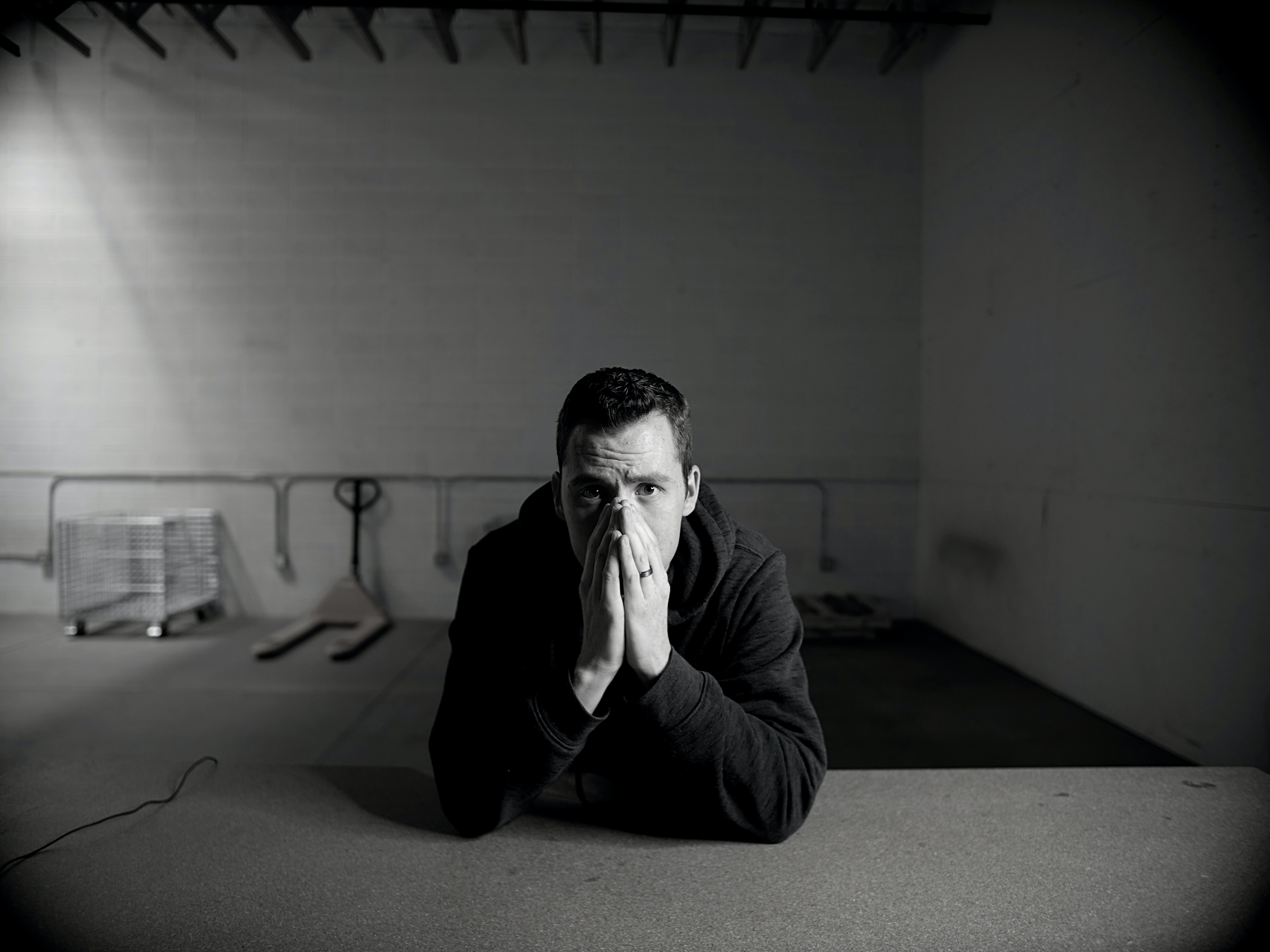 Man leaning forward covering his face with anxiety.