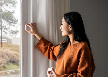 woman-installing-window-sensor