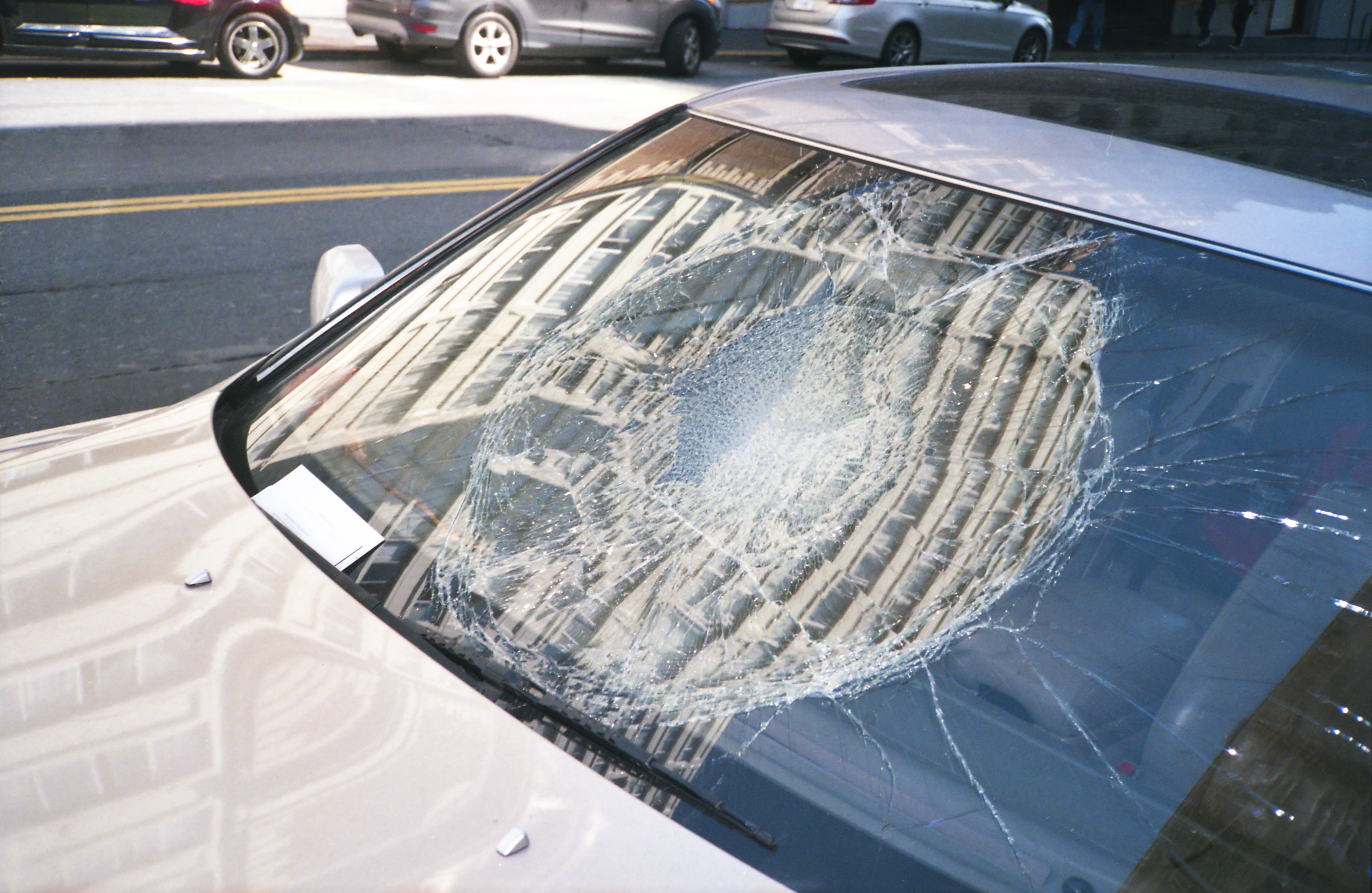 A broken windshield of a car that needs to be repaired.