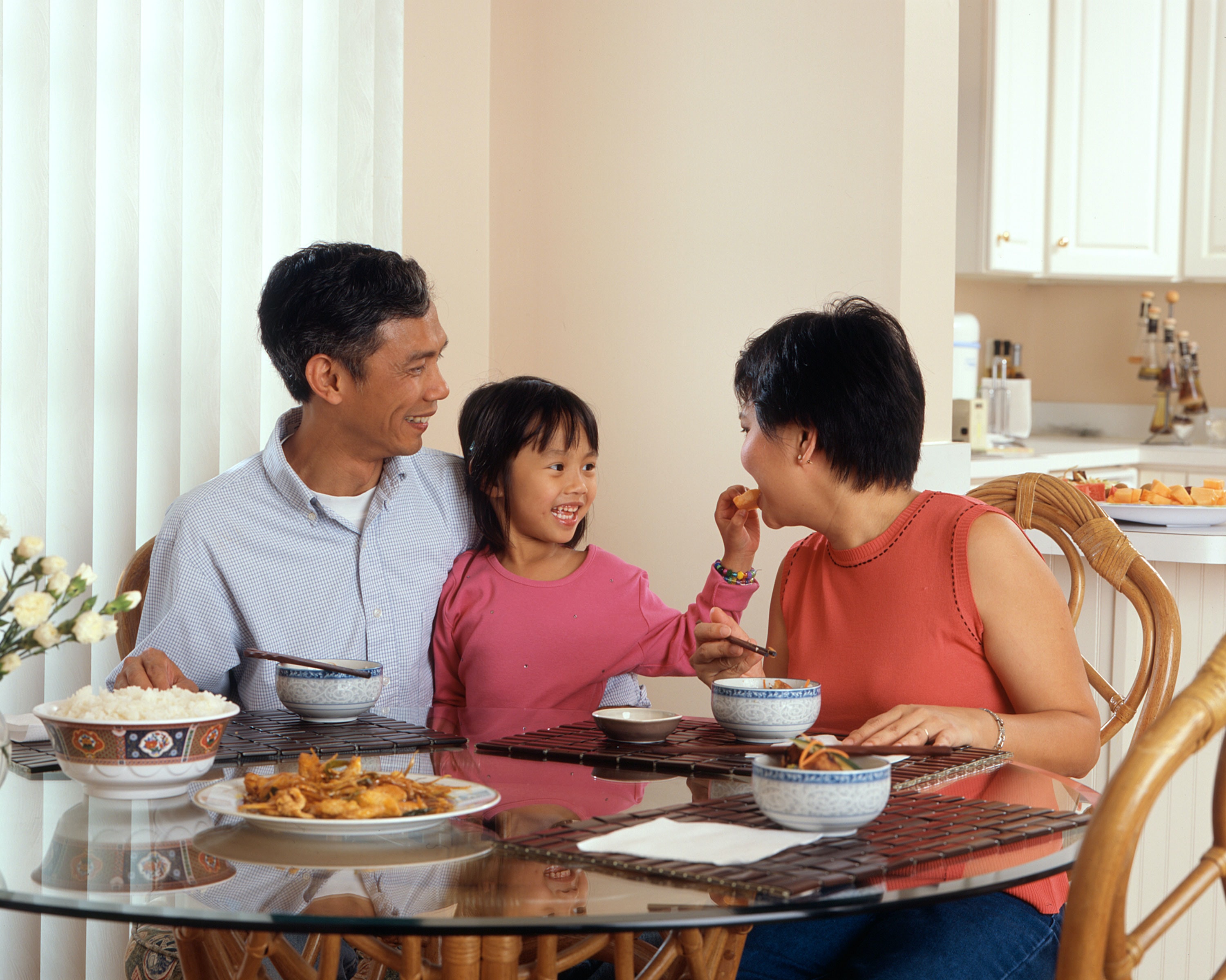 Happy family eating at the dinner table.