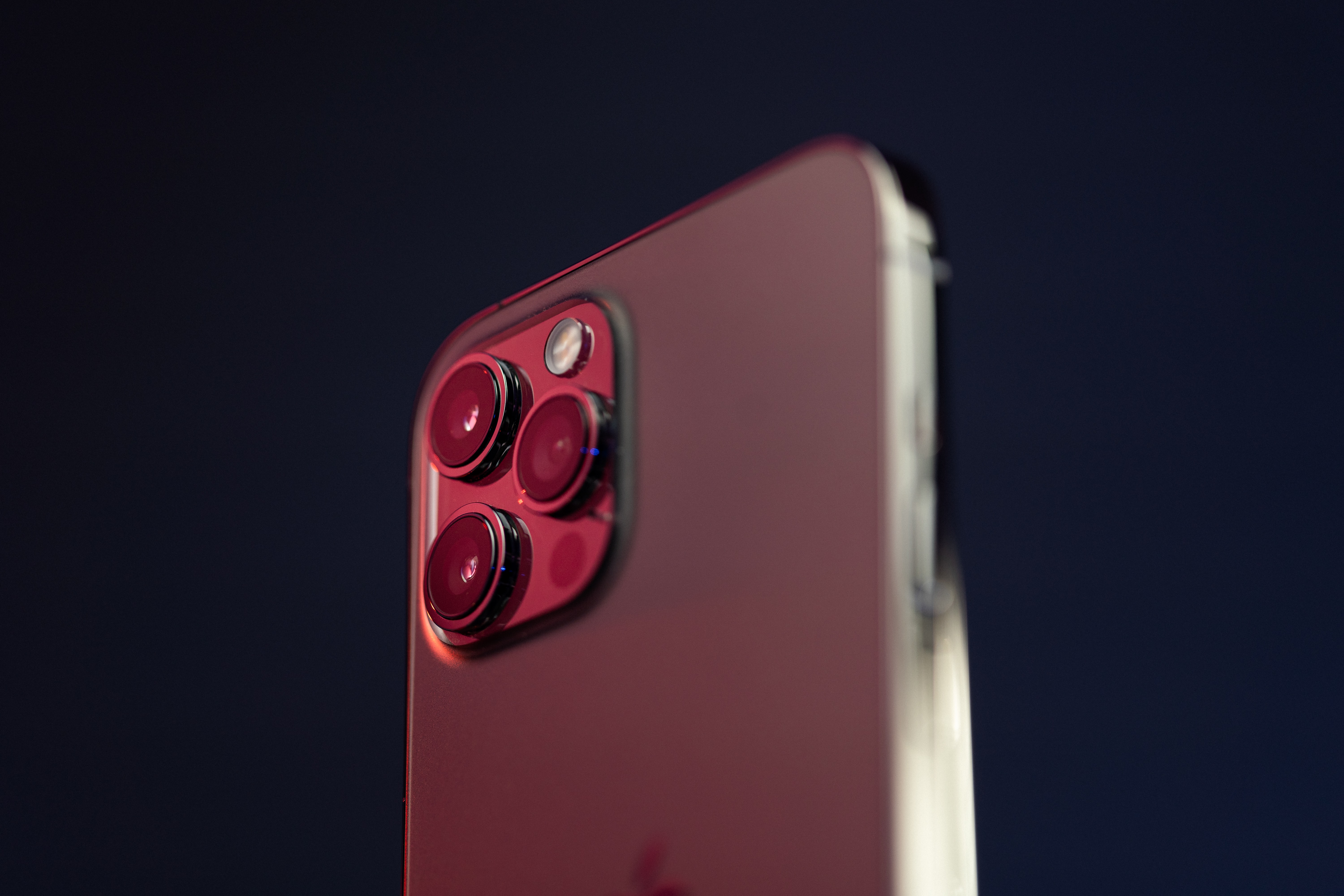 Back of an iPhone with three camera lenses.