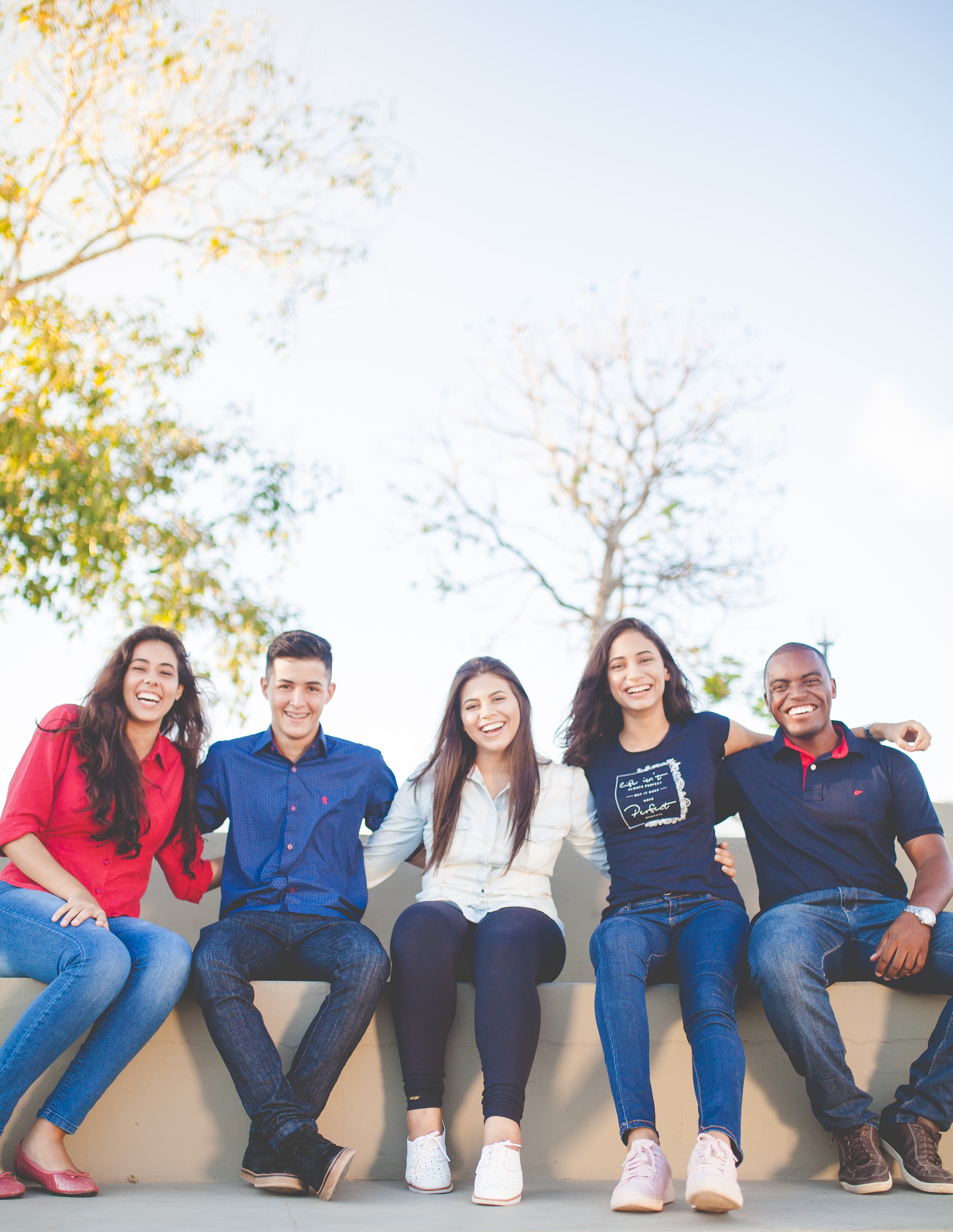 Group of young adults sitting outside.