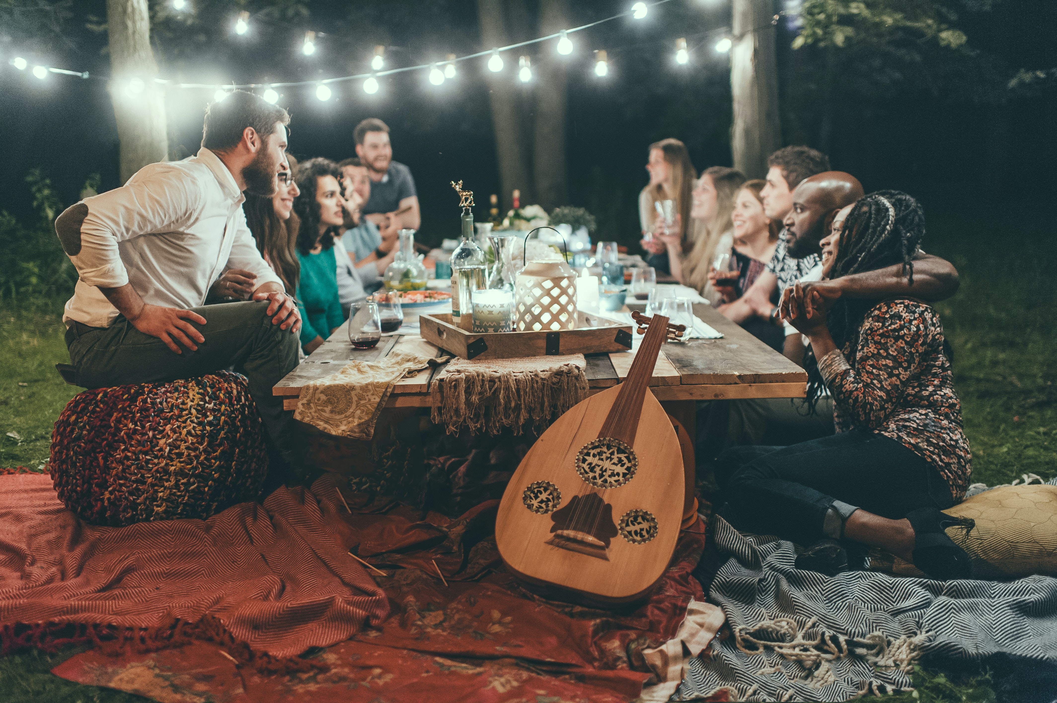 13 people around a table outside