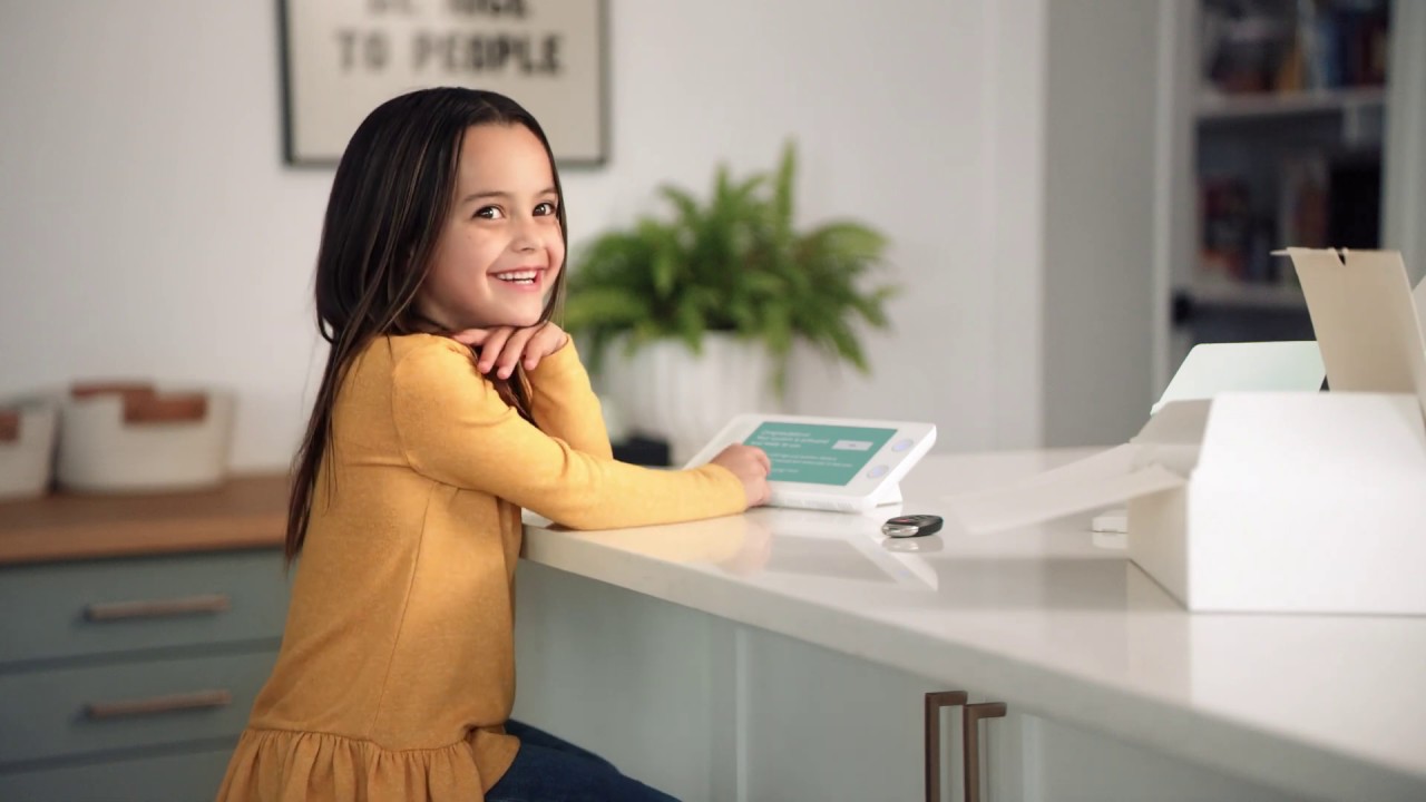 Young girl sitting at the counter with a Cove control panel.