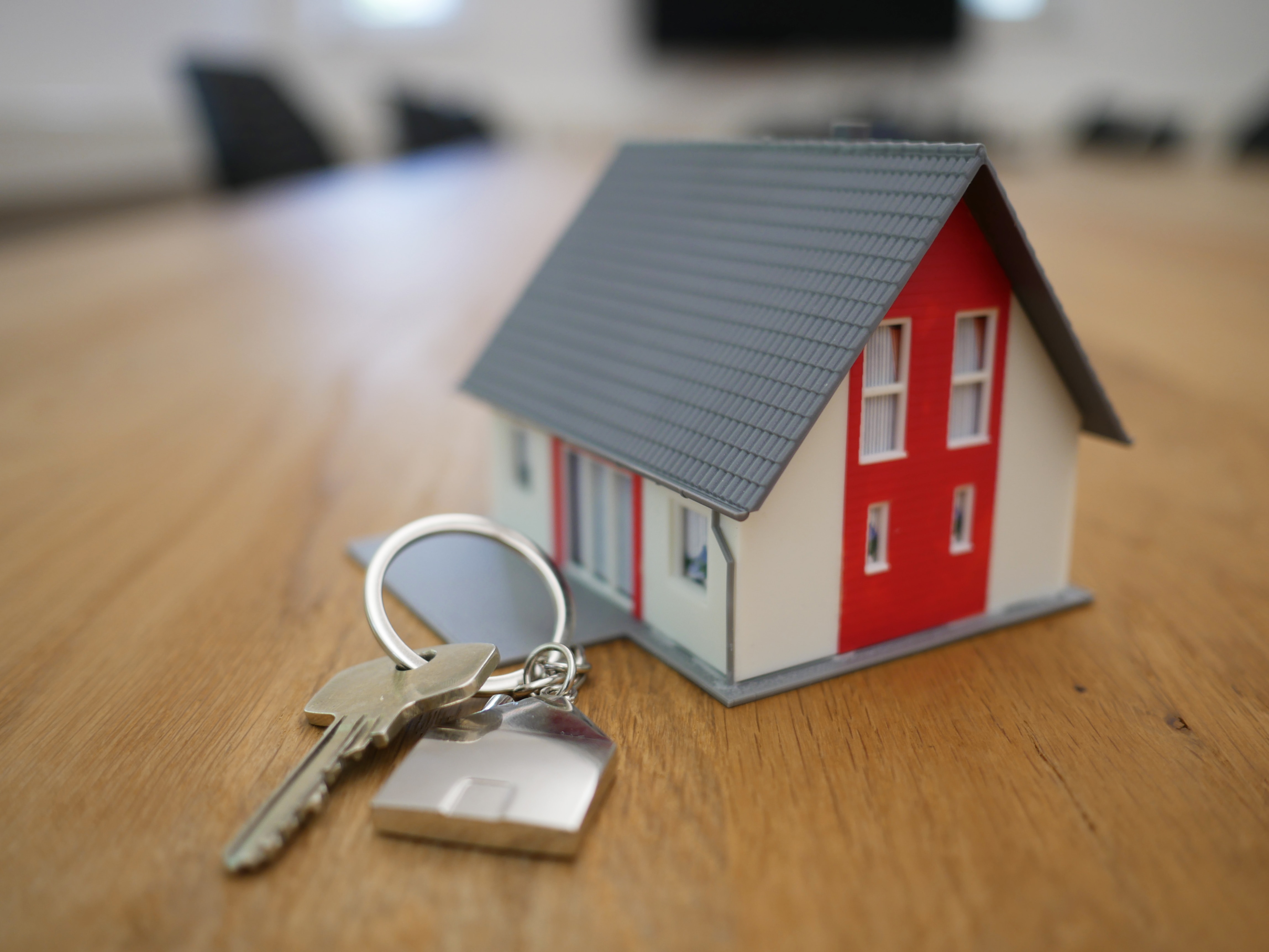 Mini house next to a set of house keys.
