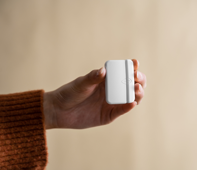 person holding cove window sensor