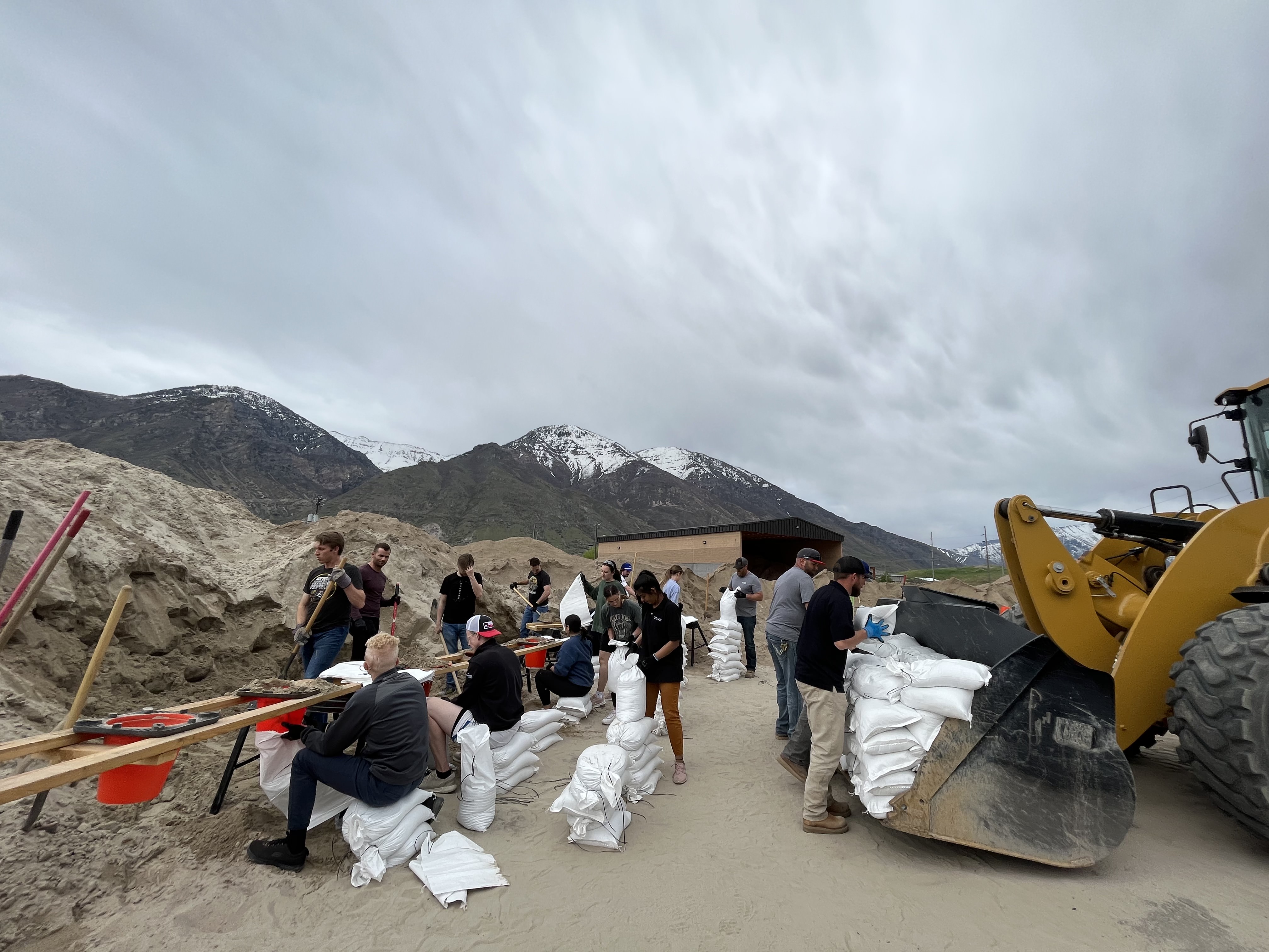 Volunteers help fill sandbags near Provo, Utah.