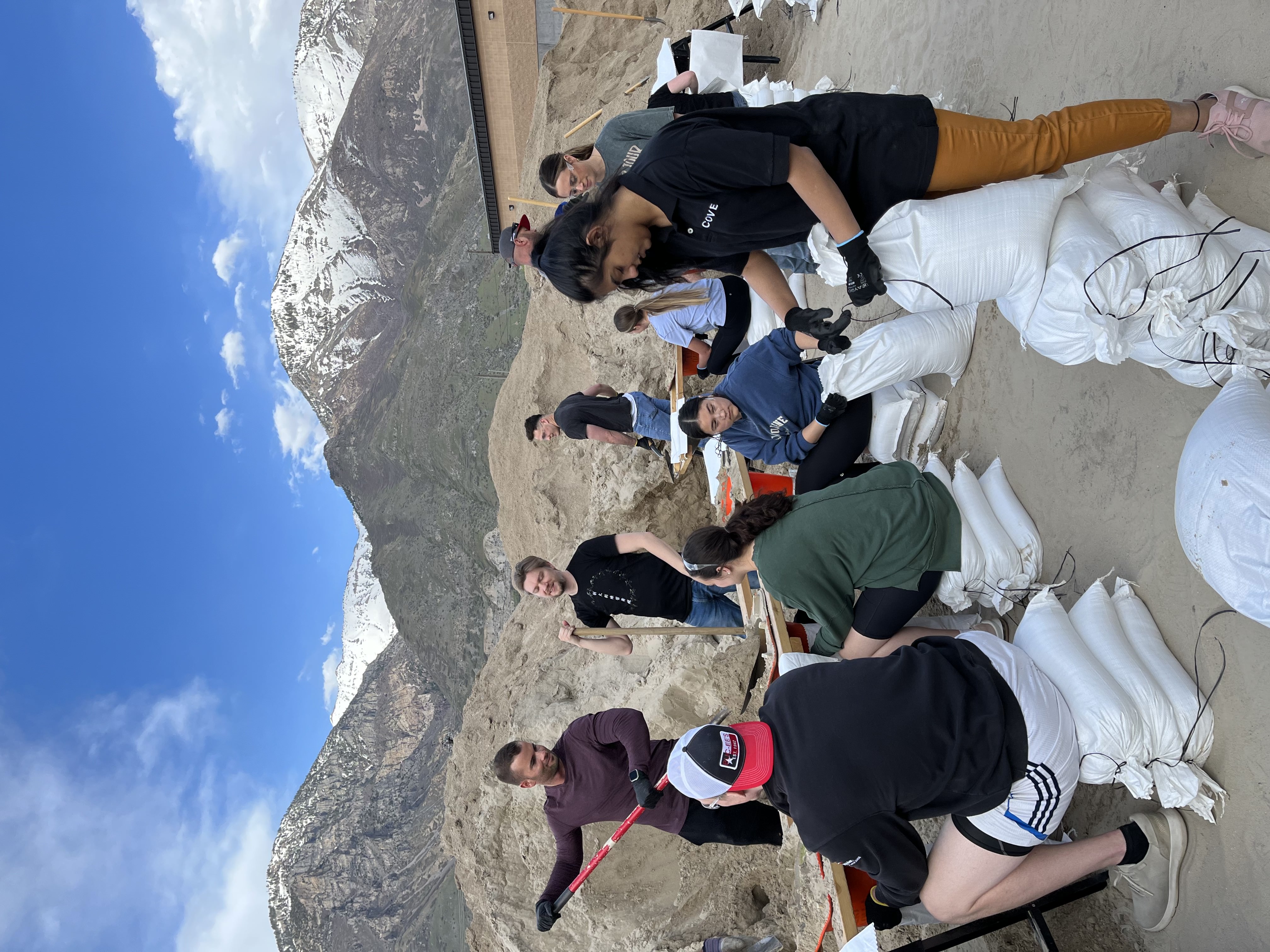 People in the Utah County community serve by filling sandbags.