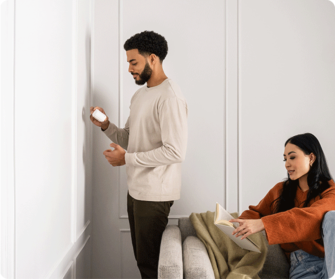 a guy installing a motion detector