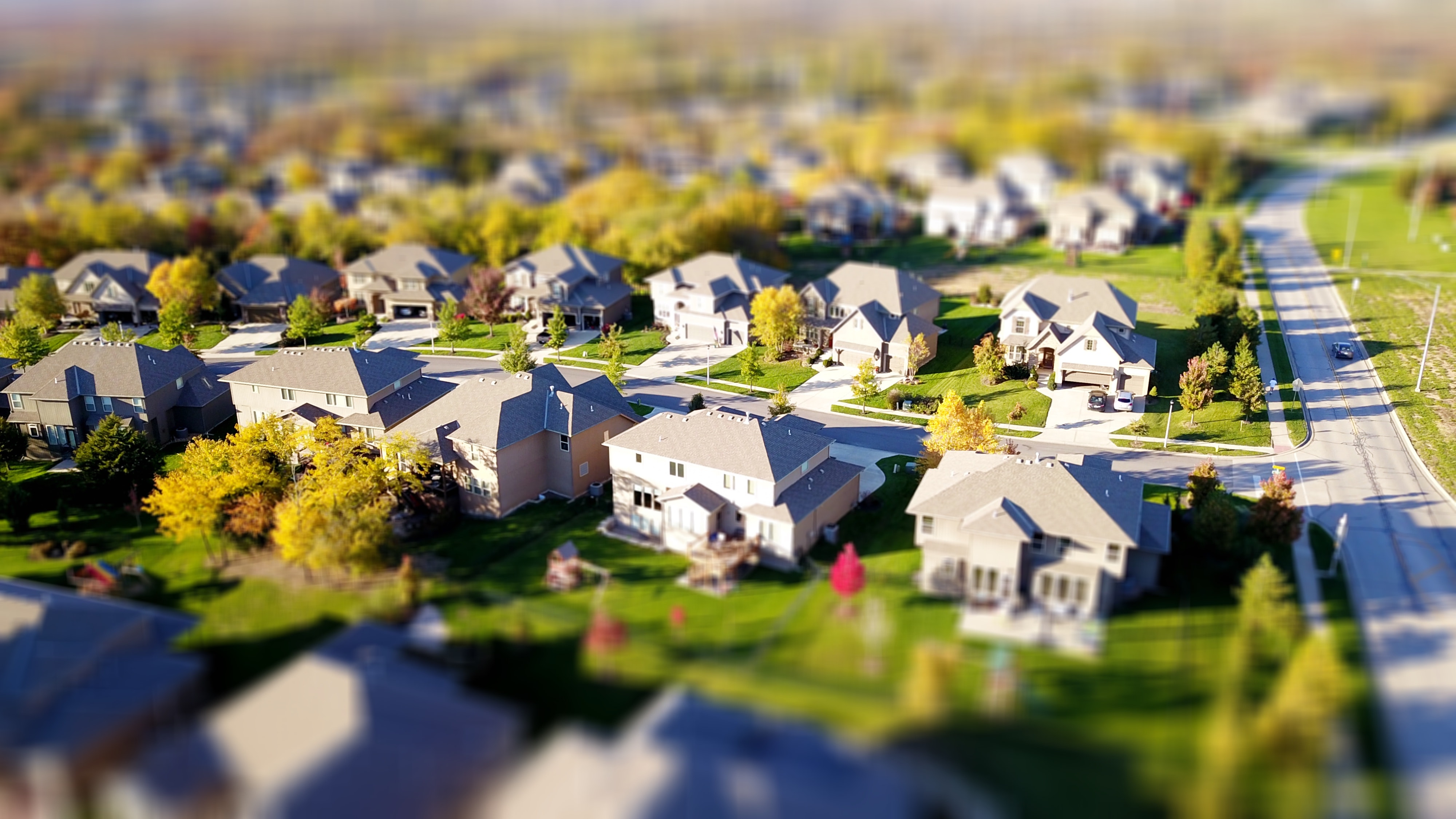 Overhead view of a neighborhood full of houses and trees and streets.