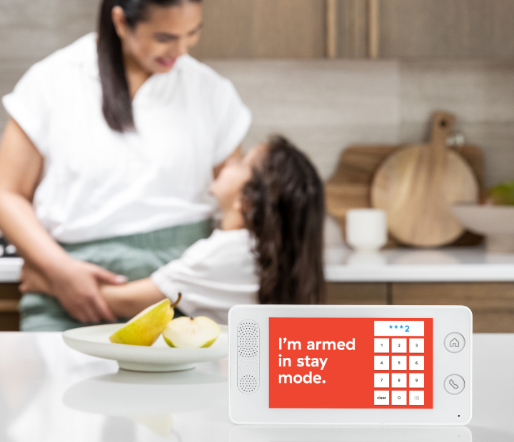 Panel on counter with mother and daughter embracing in background