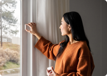 woman installing a window sensor