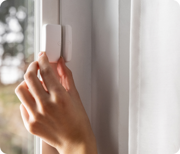 Customer installing a window sensor as part of their home security system.