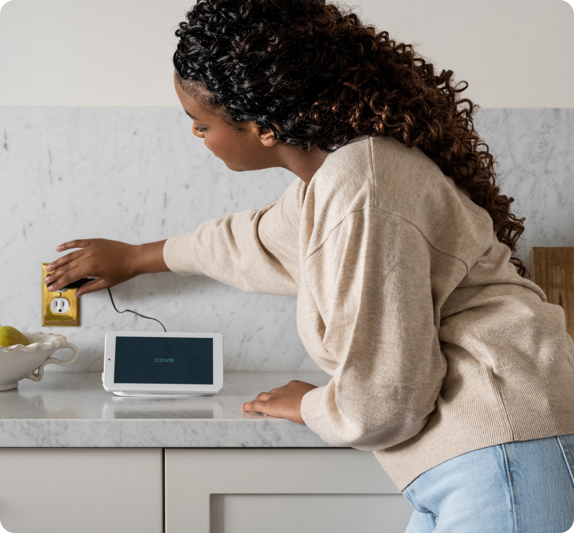 Woman installing a Cove home security system.