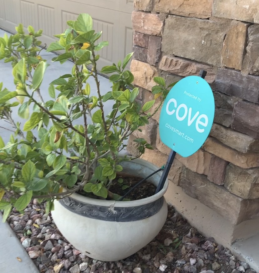 Cove home security system sign in front of a home.