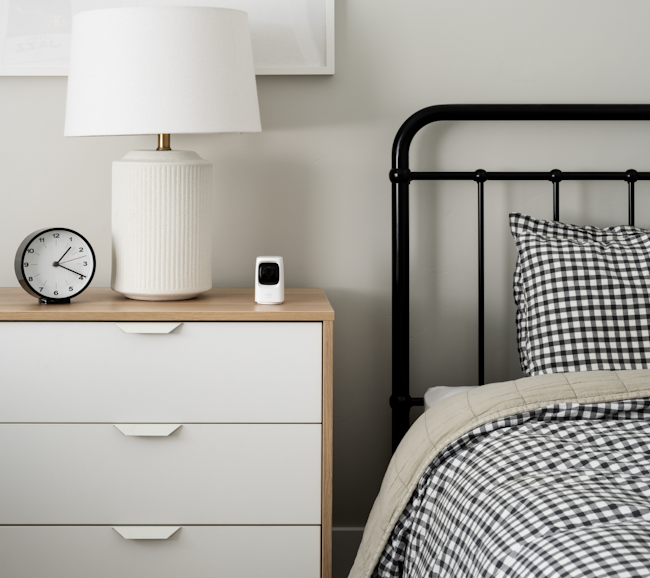 Alula eufy indoor camera on top of the bedside table