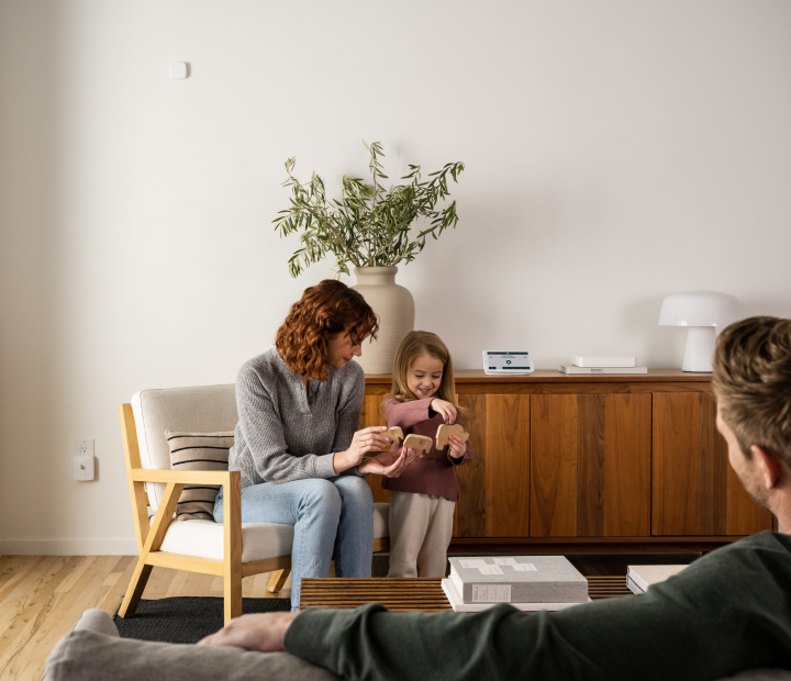 Mother and child playing at home protected by security system