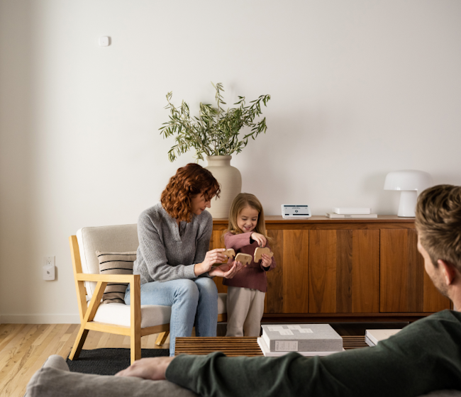 Mother and child playing at home protected by security system