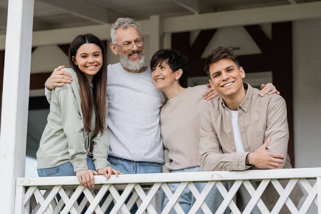 Family standing together on their porch.