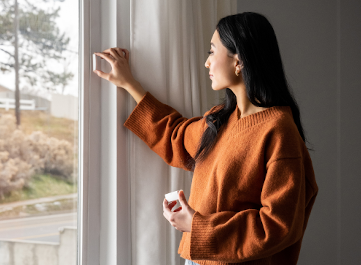 Woman installing window sensor